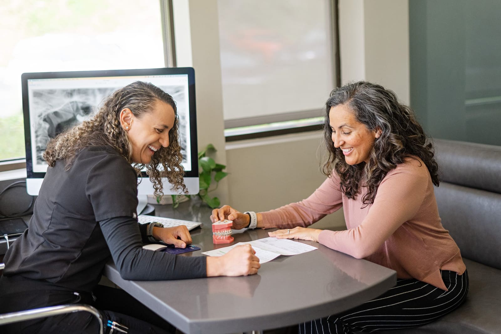 A Kinser team member walking a patient through her treatment plan and payment options