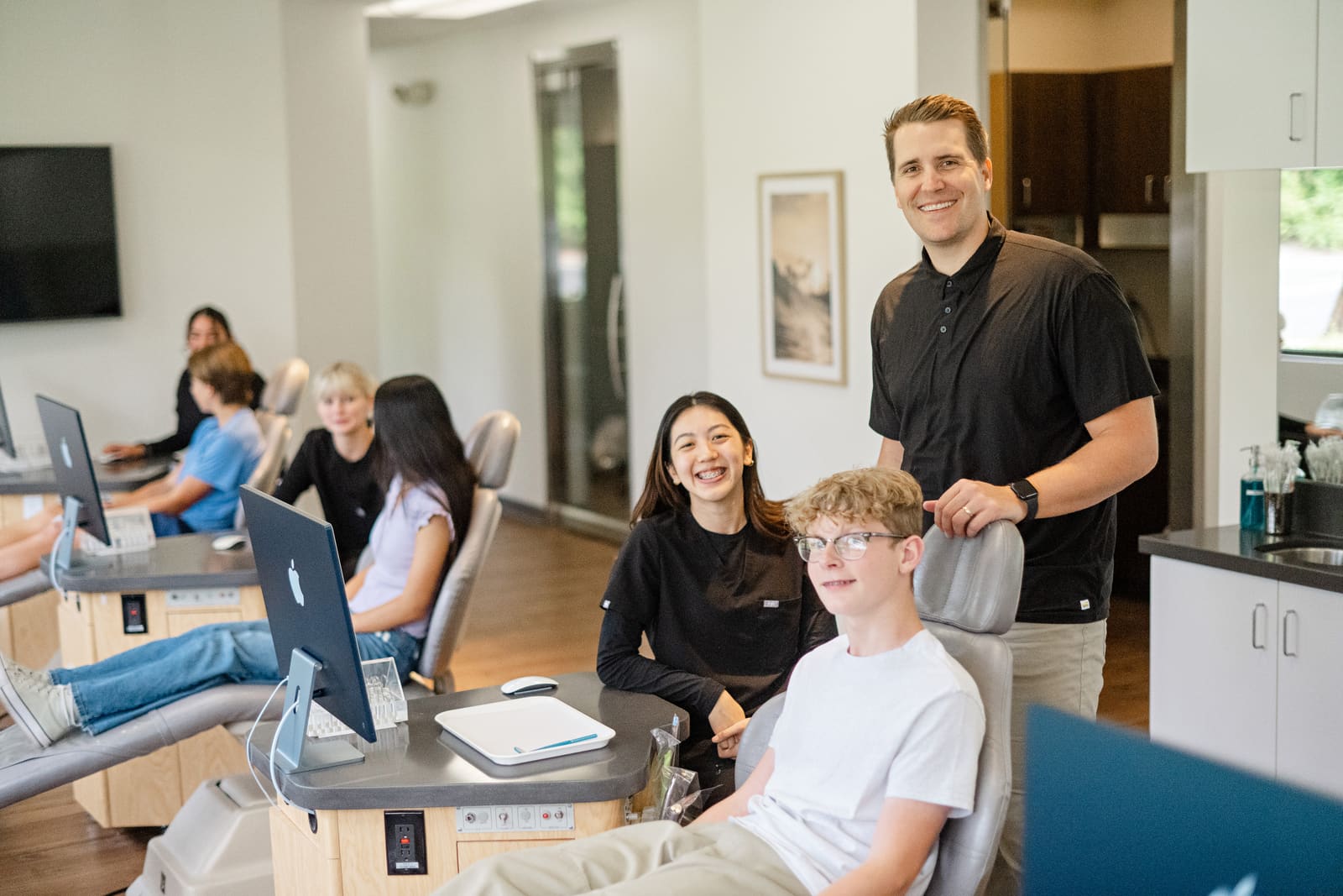 Dr. Kinser with two smiling teen patients