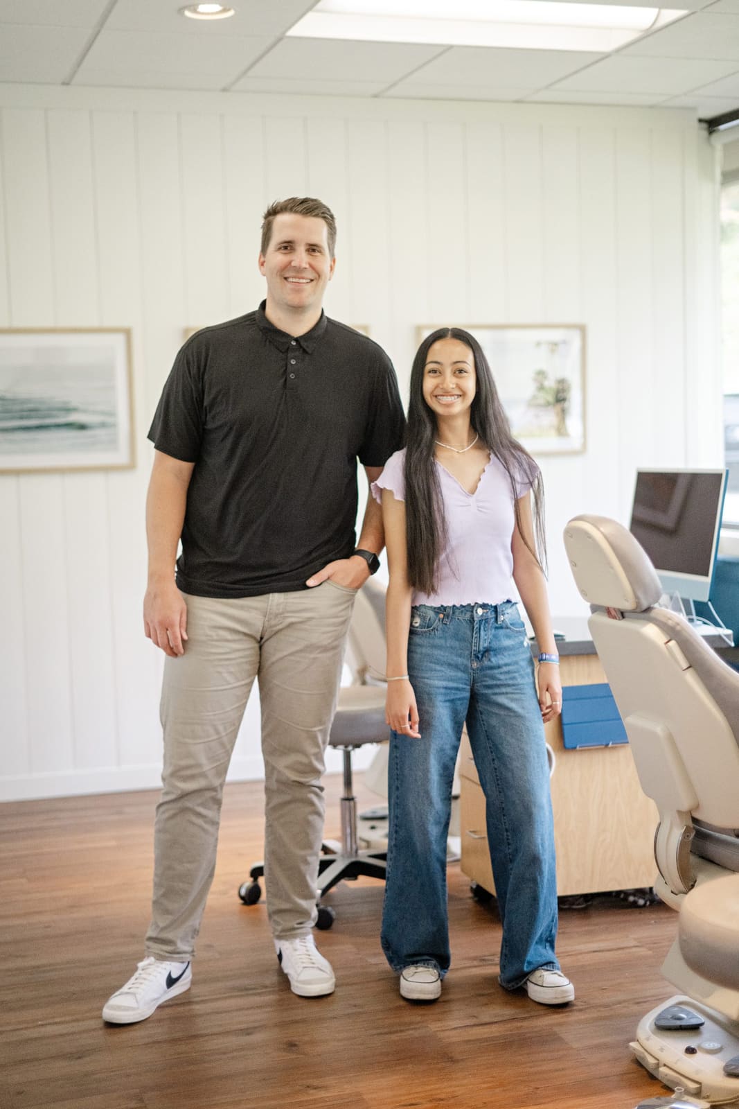 Dr. Kinser standing with a smiling teen patient in the Kinser Orthodontics treatment bay