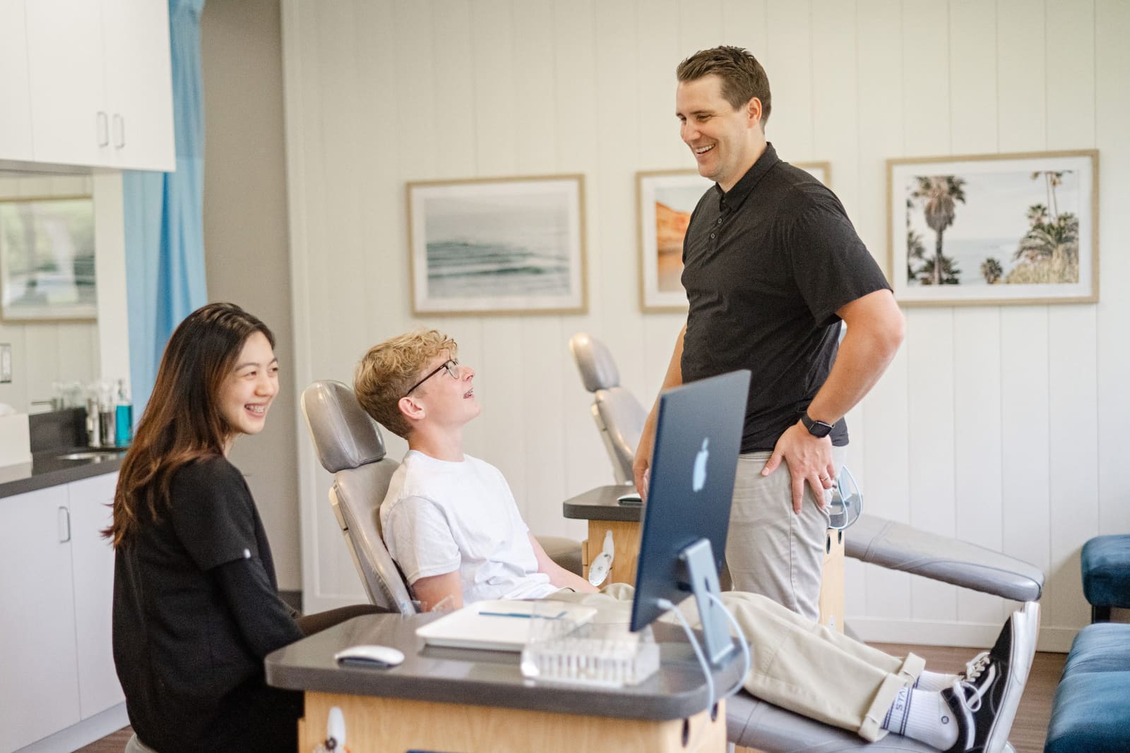 Dr. Kinser and an assistant with a young patient in the treatment chair