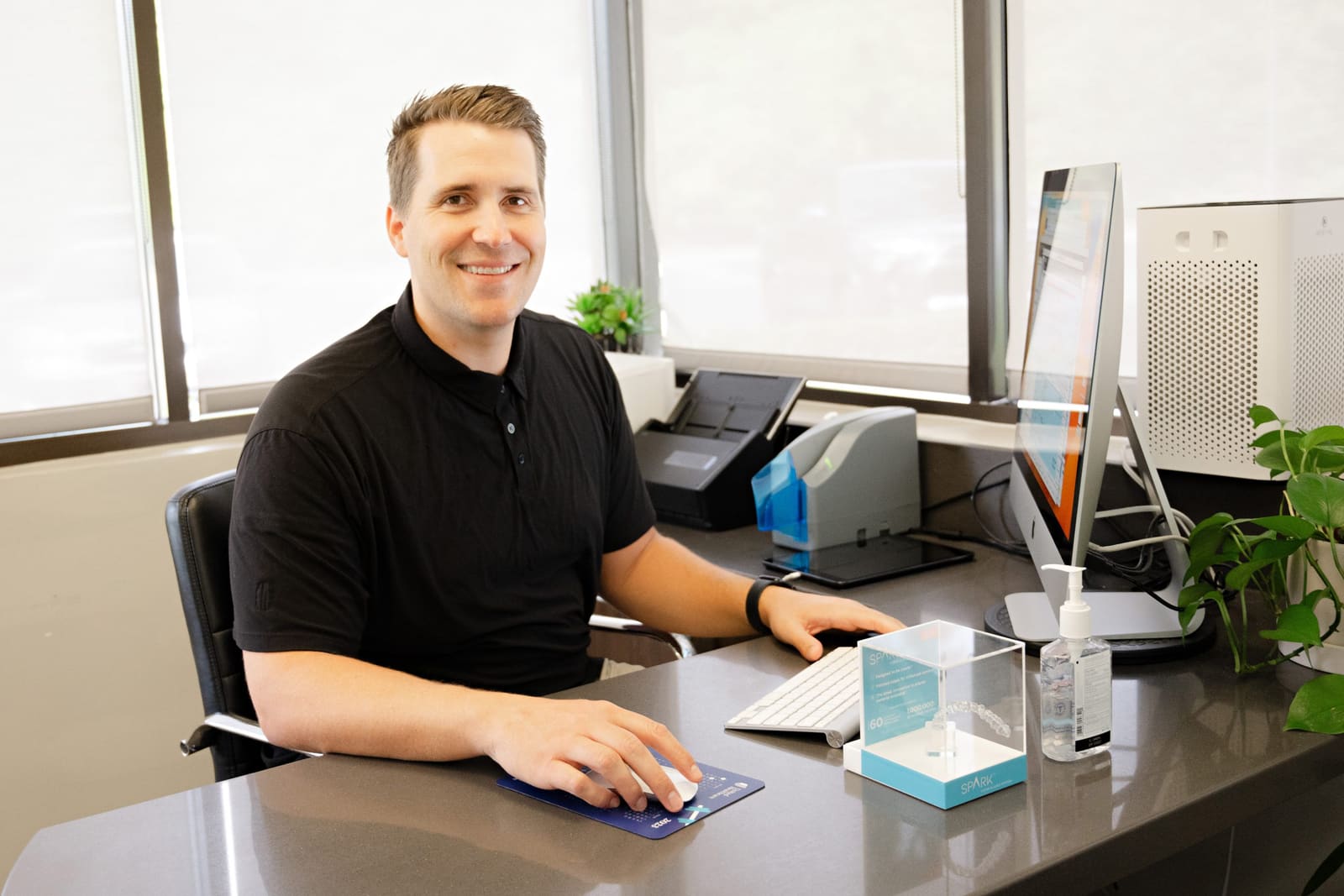 Dr. Kinser at his desk in the Kinser Orthodontics office
