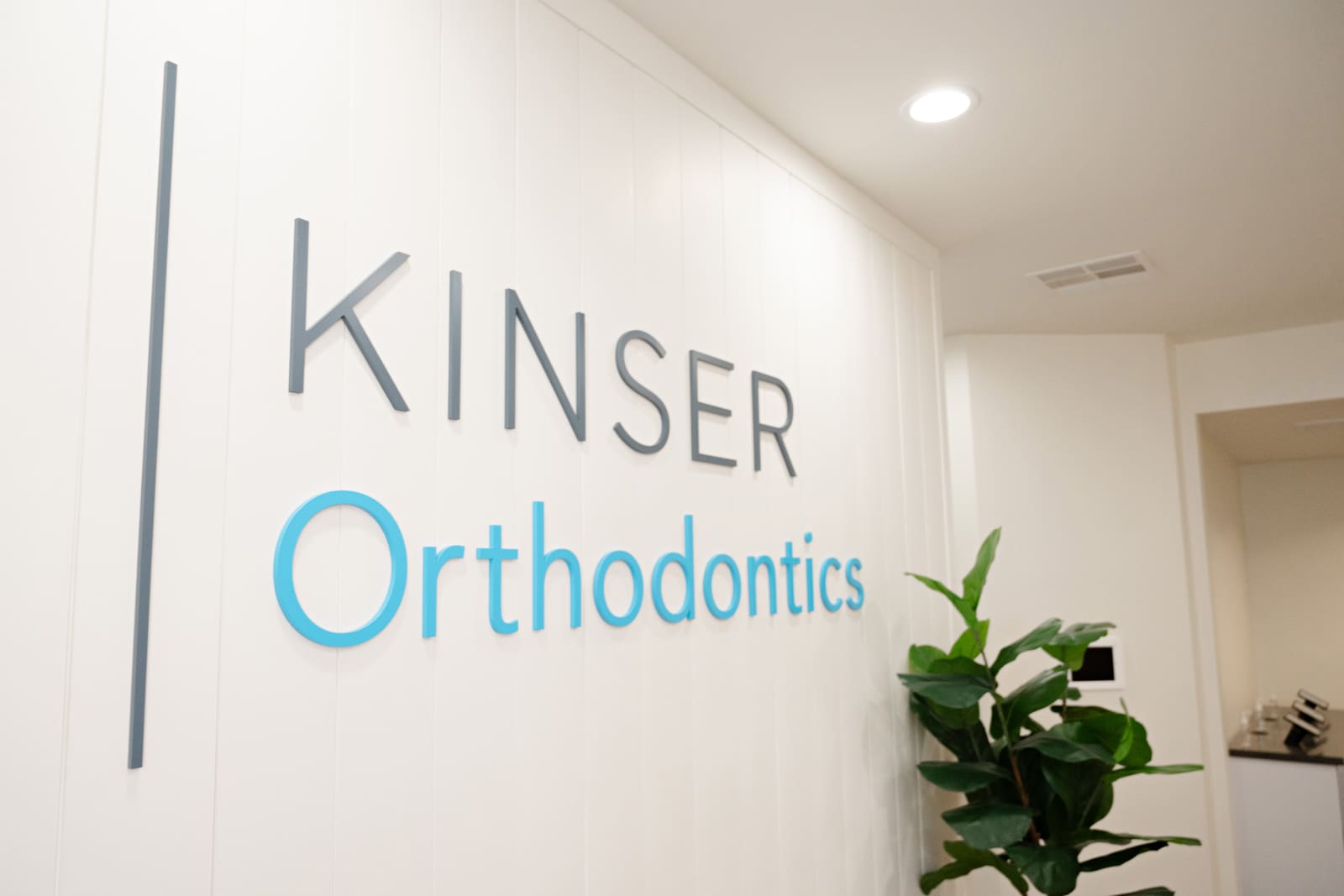 The Kinser Orthodontics wall sign inside the office
