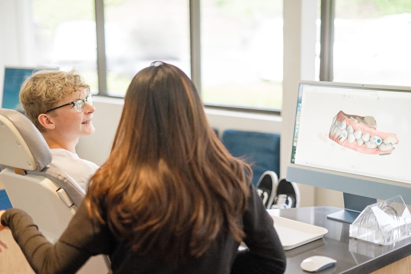 A patient viewing a 3D digital scan of her teeth on screen