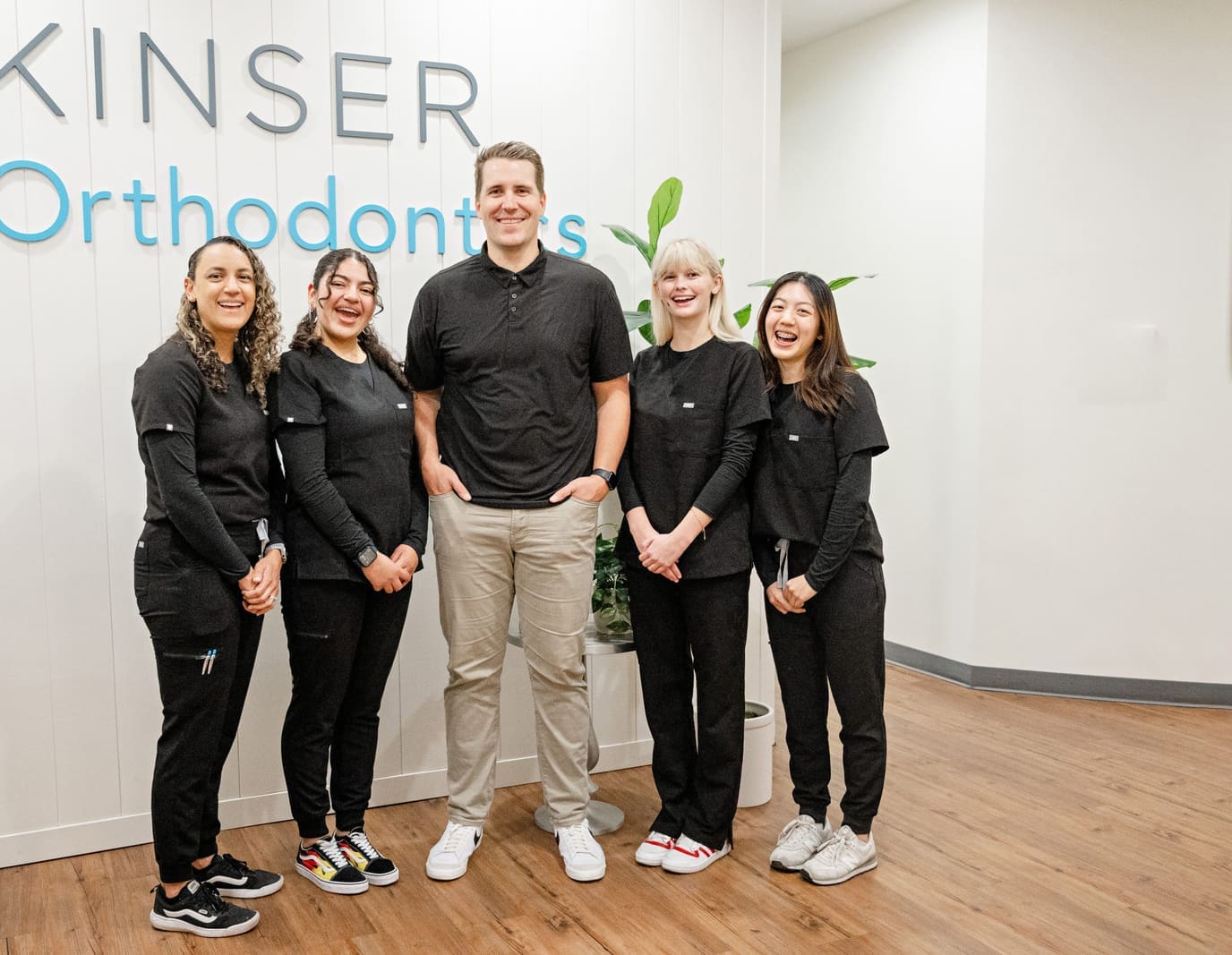 The Kinser Orthodontics team laughing together in the lobby